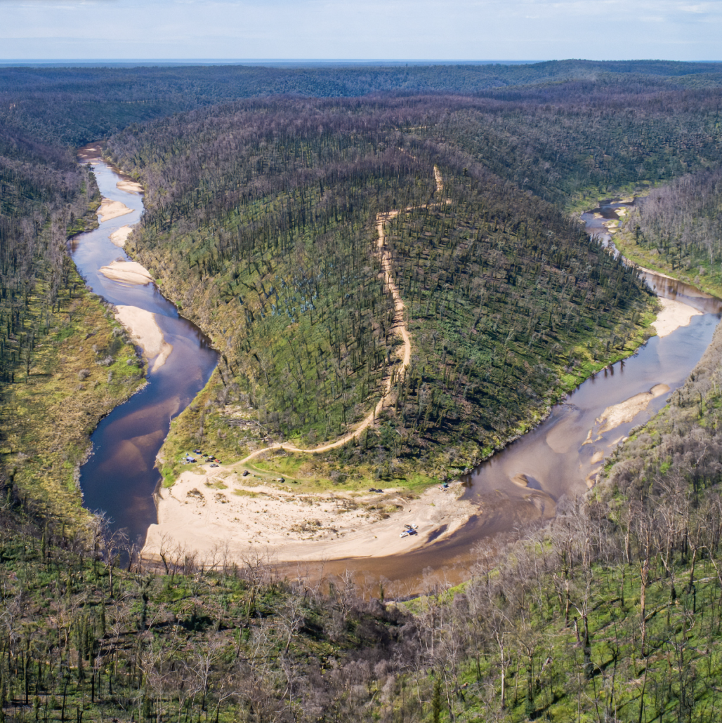 Silted river surrounded by burnt landscape