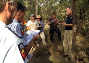 Group of people in the bush with clickboards.